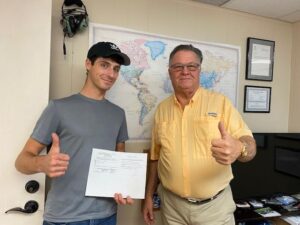 A man and a boy holding up a paper.