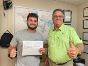 A man and his father are holding their certificate.