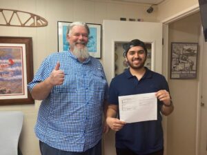 Two men celebrating with a document together.
