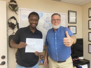 Two men celebrating success with a document.